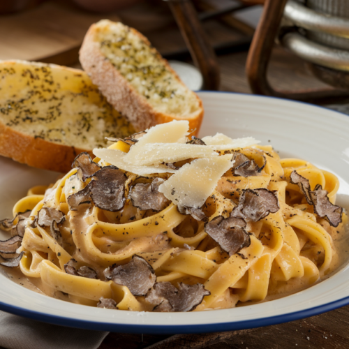 Luxurious truffle butter tagliatelle dish with shaved parmesan and truffle oil pasta garnish